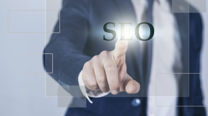 Search Engine Optimization consultant touching SEO button